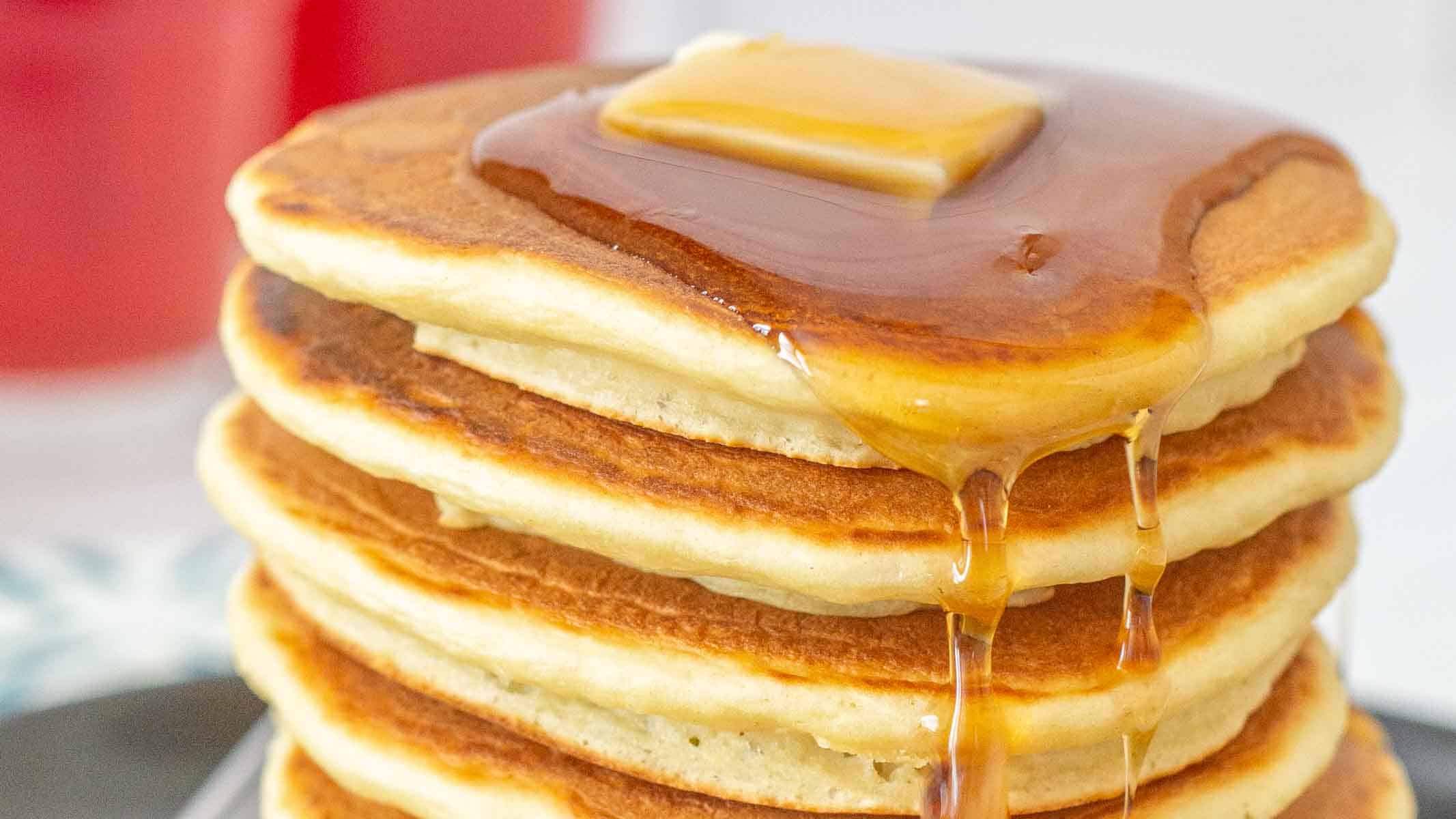 Fluffy pancakes made with applesauce and topped with maple syrup.