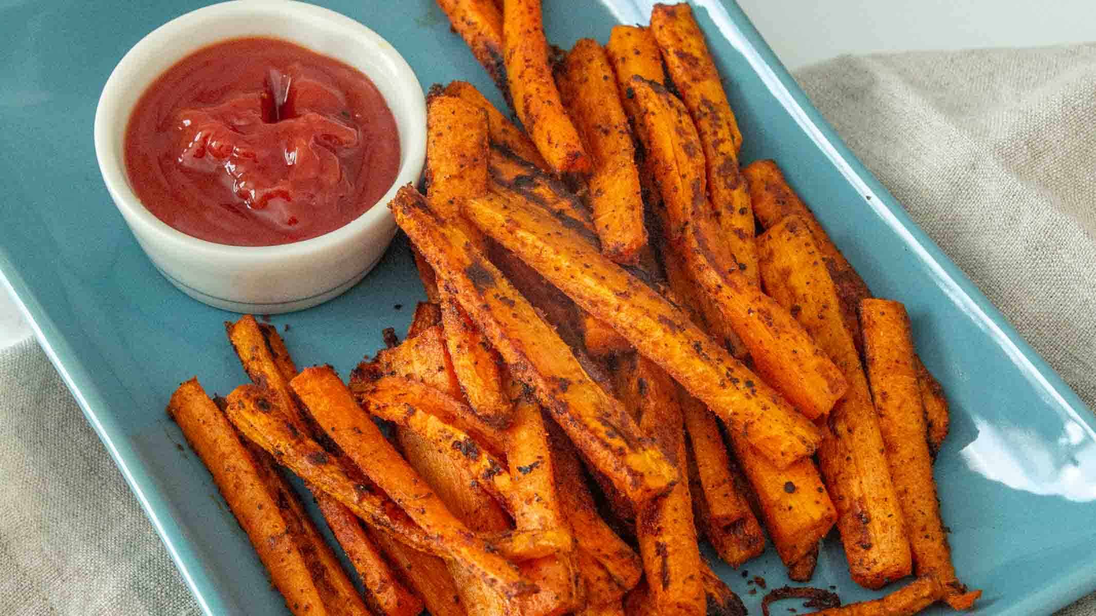Oven-baked carrot fries on  plate.