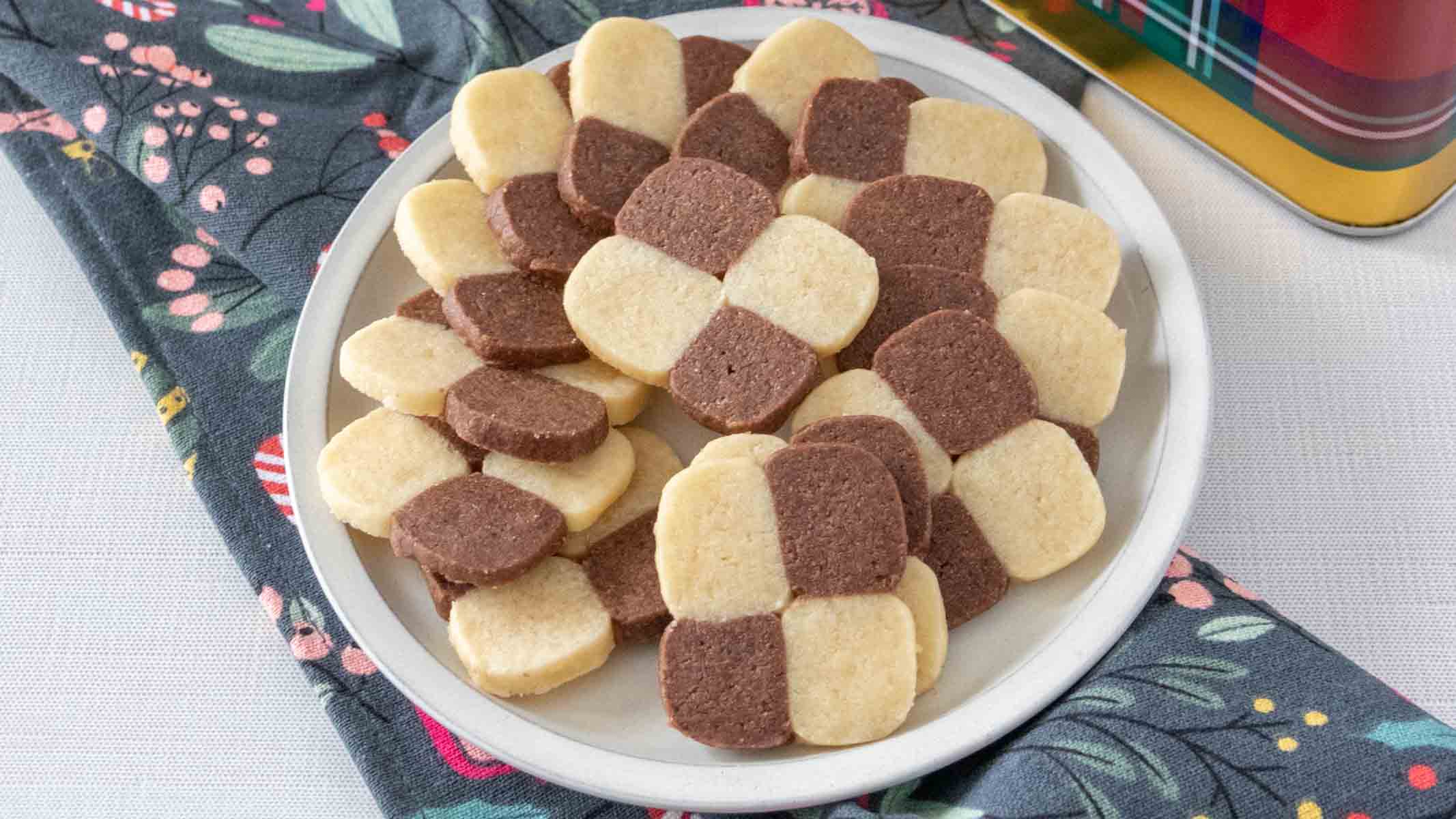 Checkerboard cookies sliced to reveal a neat chocolate and vanilla pattern.