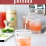 A cocktail shaker pours pink liquid into a salt-rimmed glass on a counter, labeled "blood orange paloma" at the top of the image.