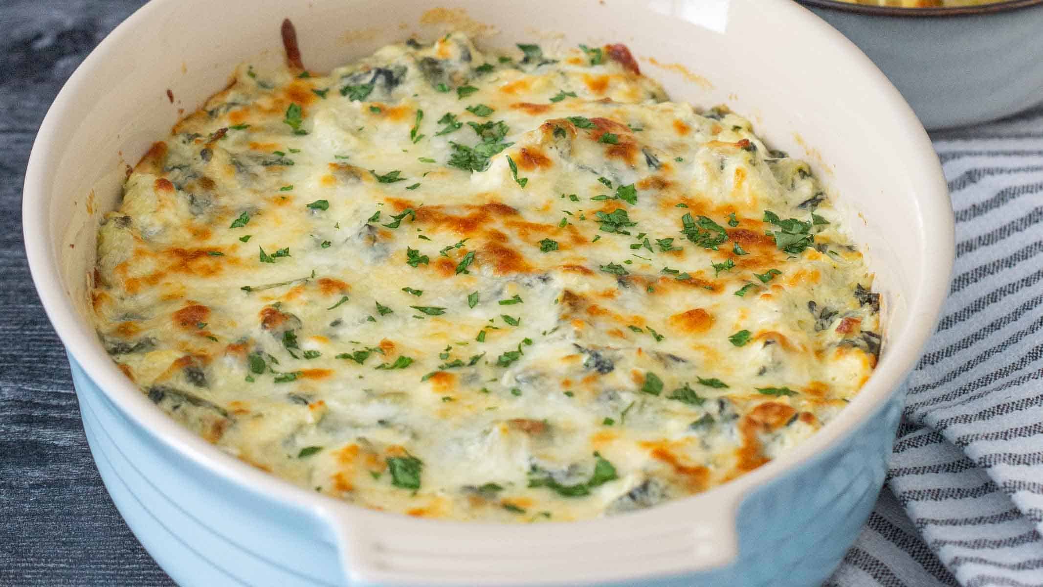Spinach artichoke dip in a baking dish.