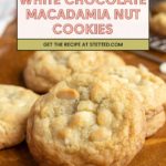 Close-up of white chocolate macadamia nut cookies on a wooden surface, with a wire rack of cookies in the background. A label above reads, "White Chocolate Macadamia Nut Cookies.