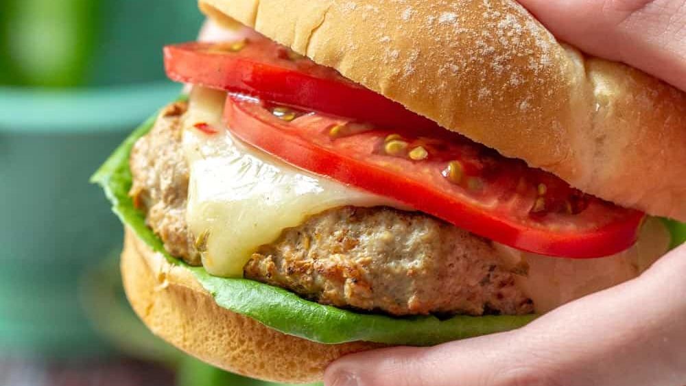hands holding hatch chile turkey burger