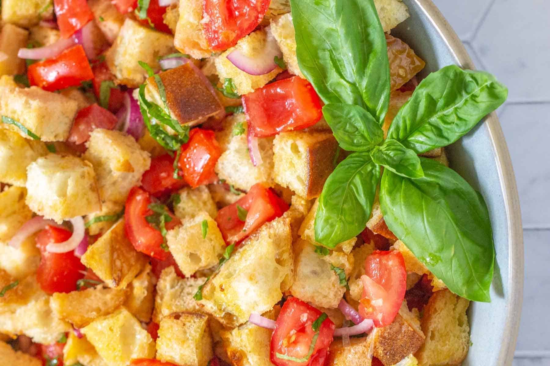 close up of panzanella salad with basil leaves