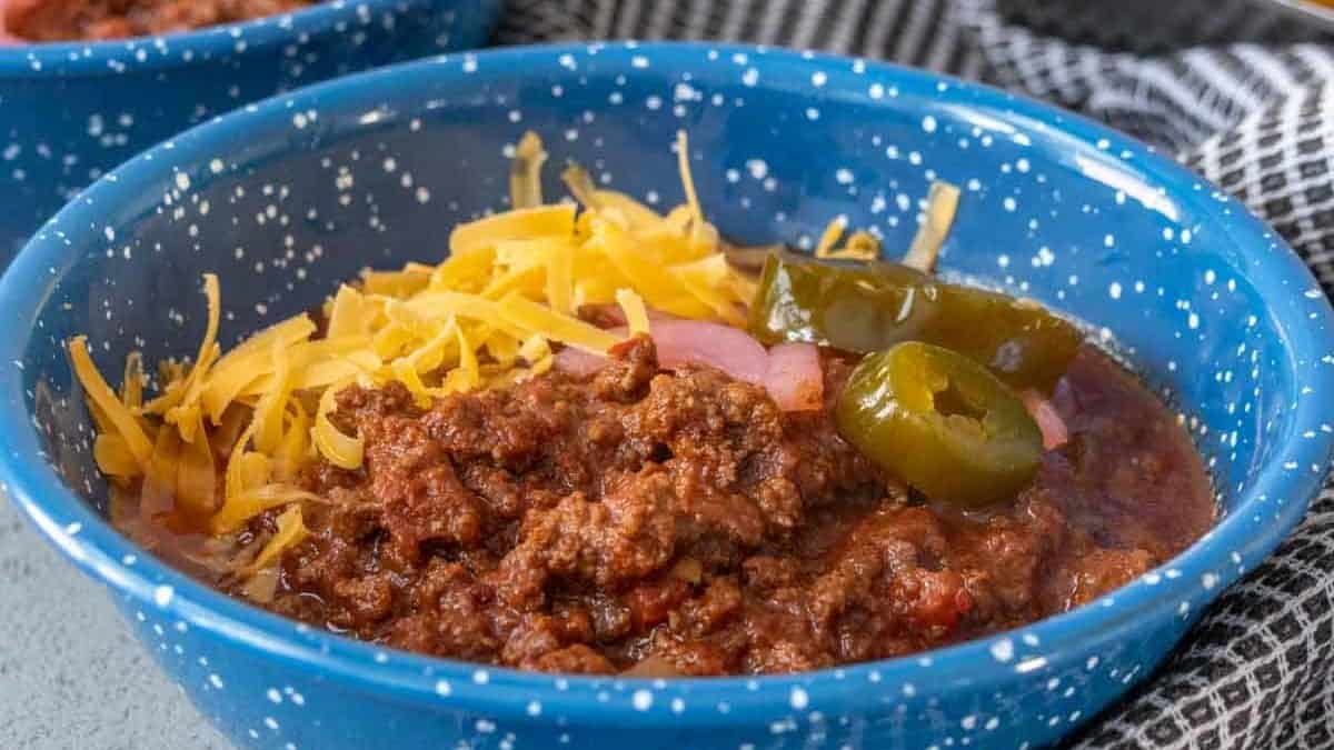 Blue enamel bowl of bison chili.