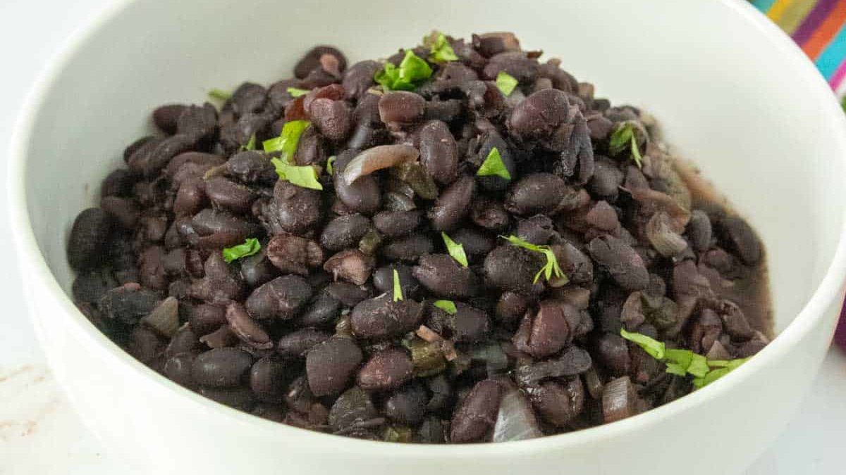Mexican black beans in a white bowl.