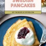 A plate of folded Swedish pancakes topped with whipped cream and berry jam, with a fork on the side. A recipe card above reads “Swedish Pancakes.”.