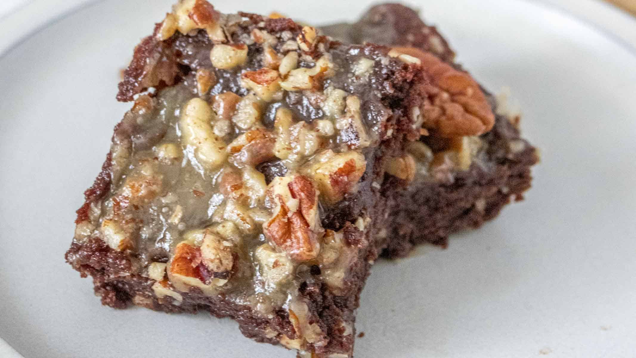 Chocolate brownies topped with caramel, pecans, and more chocolate.