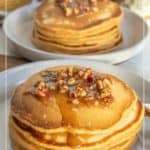 A stack of sweet potato pancakes topped with chopped pecans and syrup sits on a plate, with another stack visible in the background.