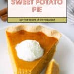 A slice of sweet potato pie topped with whipped cream sits on a white plate, with a fork holding a bite-sized piece.