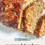 A sliced ground turkey meatloaf with a glossy glaze, garnished with herbs, on a white plate. Text below reads "ground turkey meatloaf.