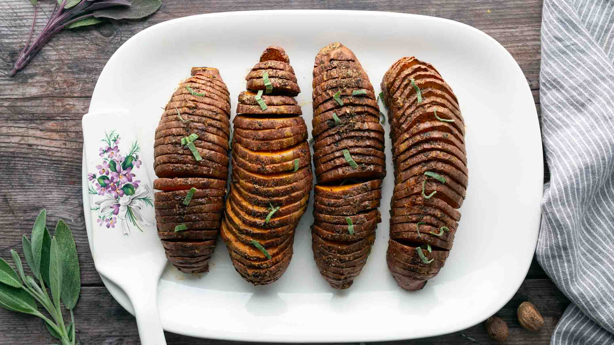 Hasselback sweet potatoes on a serving platter.