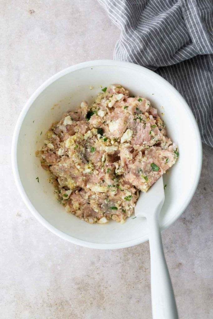 A bowl of food with a spoon.