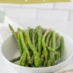 A white bowl filled with sautéed asparagus spears sits on a white surface, with text reading "sautéed asparagus" and "simple spring side.