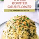 Whole roasted cauliflower topped with herbs and breadcrumbs, served on a white plate with a pool of sauce. Text overlay reads, "Whole Roasted Cauliflower. Get the recipe at stetted.com.