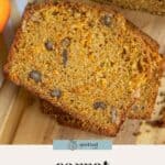 Sliced carrot quick bread with visible walnuts on a wooden board, accompanied by a label reading "carrot quick bread.