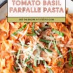 A plate of farfalle pasta topped with creamy tomato basil sauce, grated cheese, and fresh basil strips.