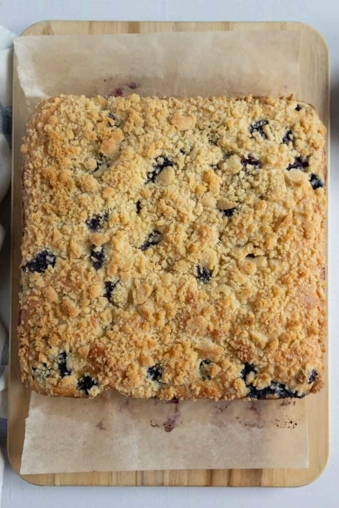 A baked blueberry coffee cake on a cutting board.