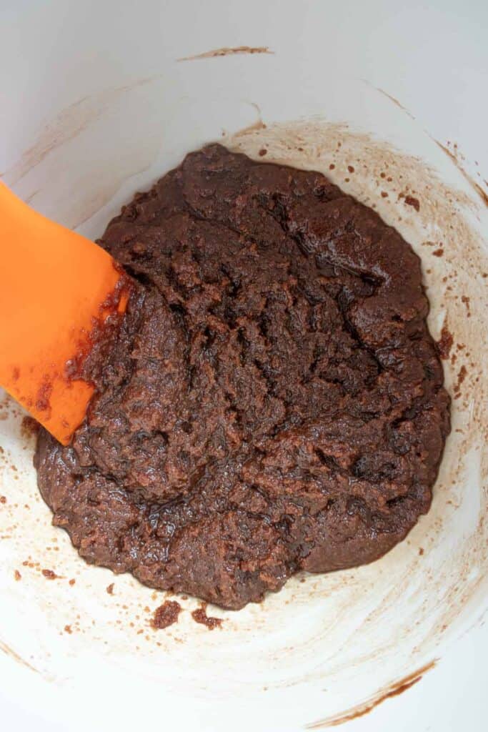 A white bowl filled with a chocolate batter.