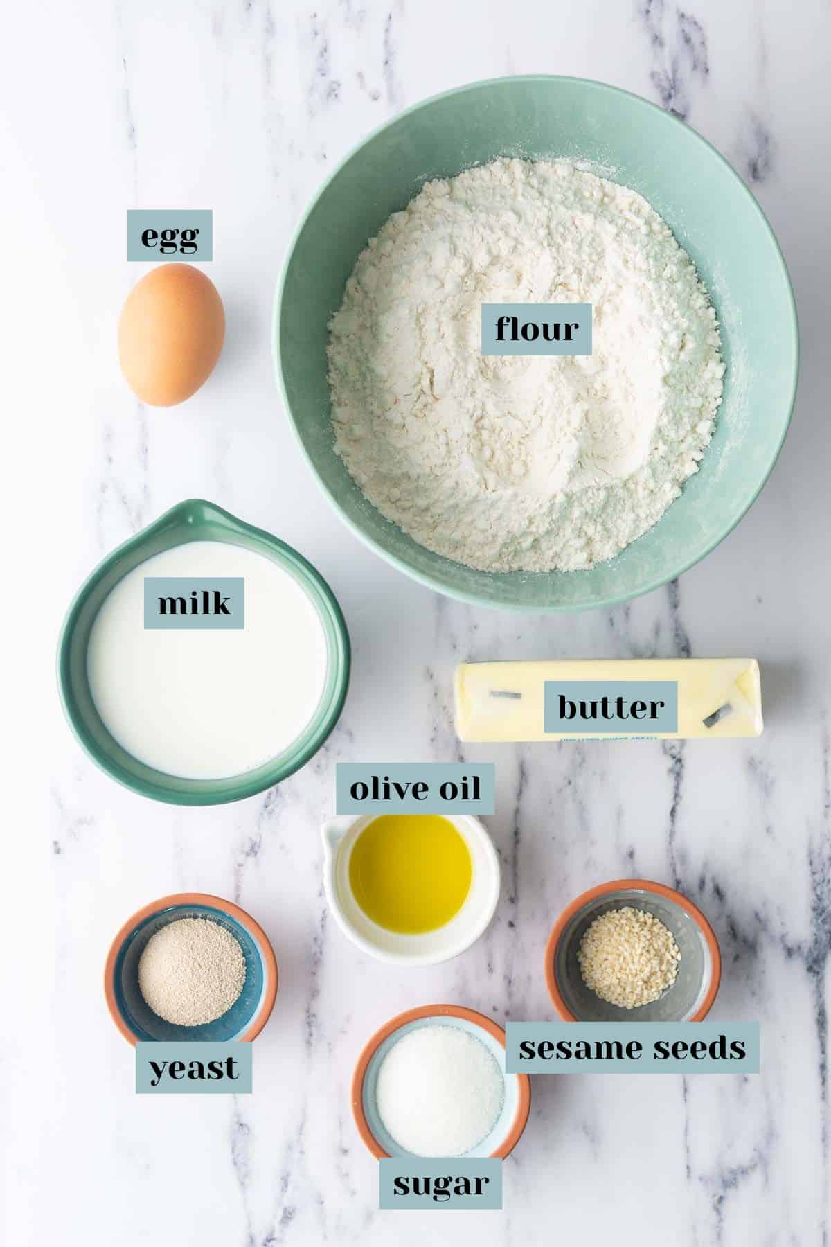 Ingredients for a bun recipe laid out on a countertop with labels.