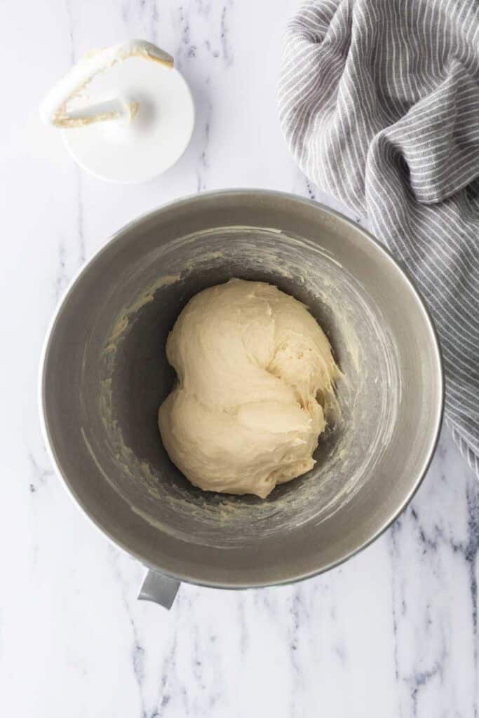 A basic dough in a stand mixer bowl.