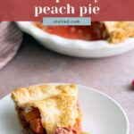 A slice of raspberry peach pie on a white plate with a fork, with the rest of the pie in the background.